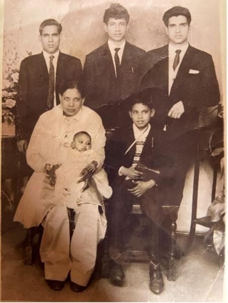 Photo of grandfather Charan Singh Mattu (top left with family, including my dad top-middle)